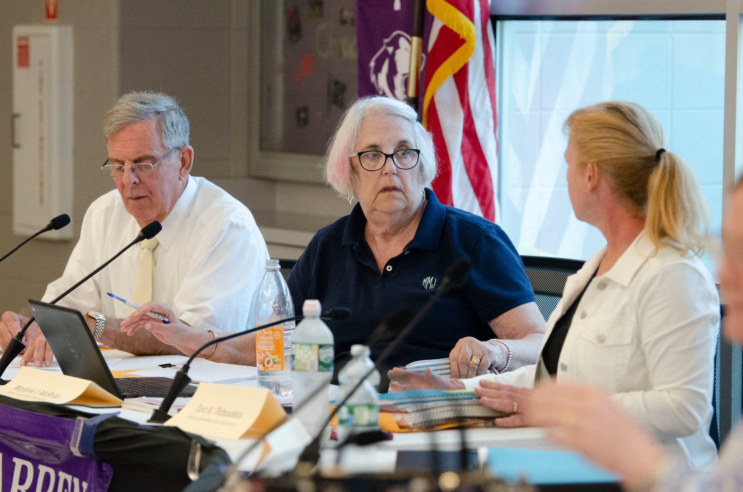 School committee members Victor Cabral, Marjorie McBride and Tara Thibaudeau discuss a point made by a resident during the open meeting.