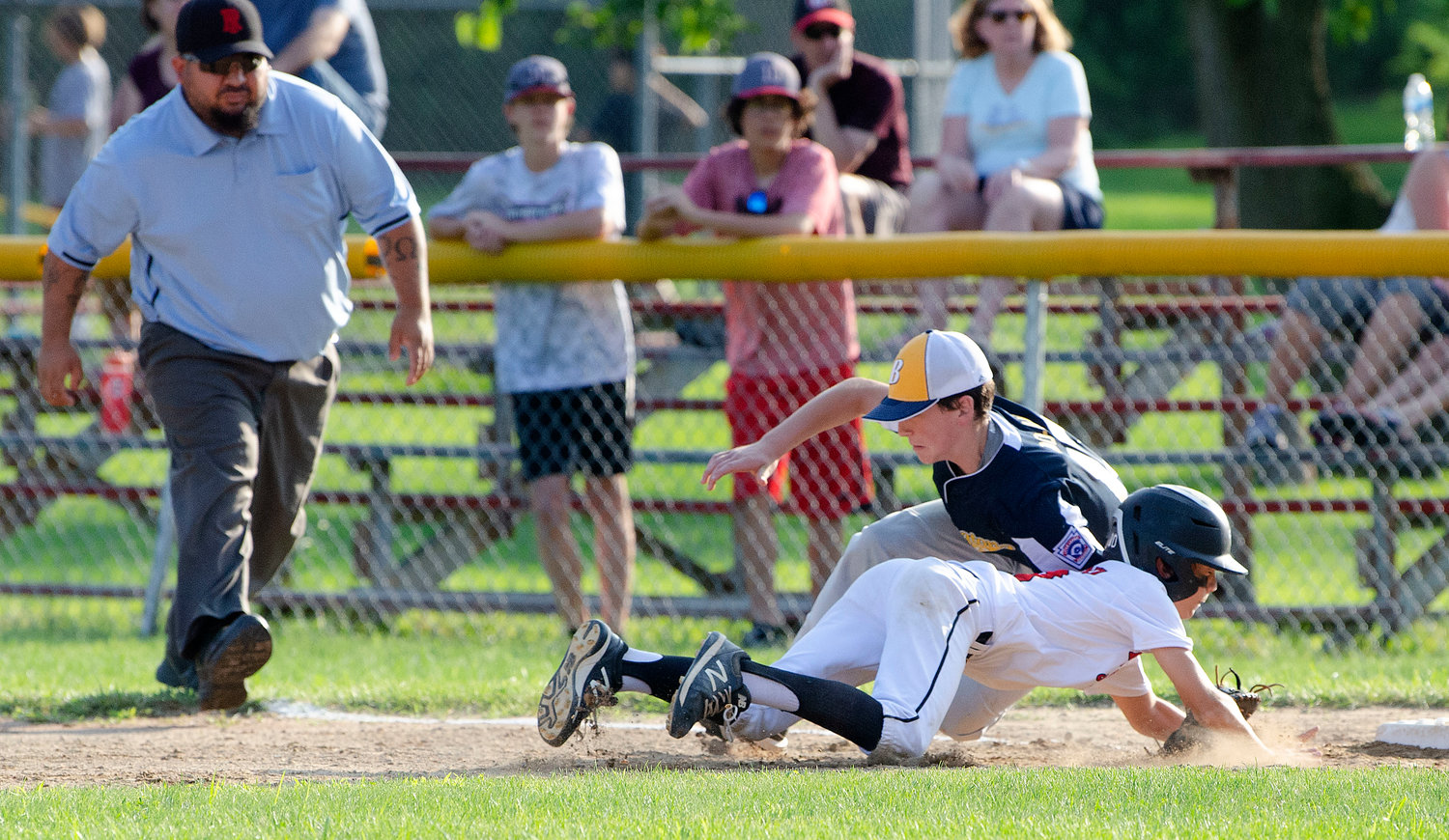 Barrington's Miles Dolan applies the tag to Riverside's JJ Renaud during the first game of the District 2 finals.