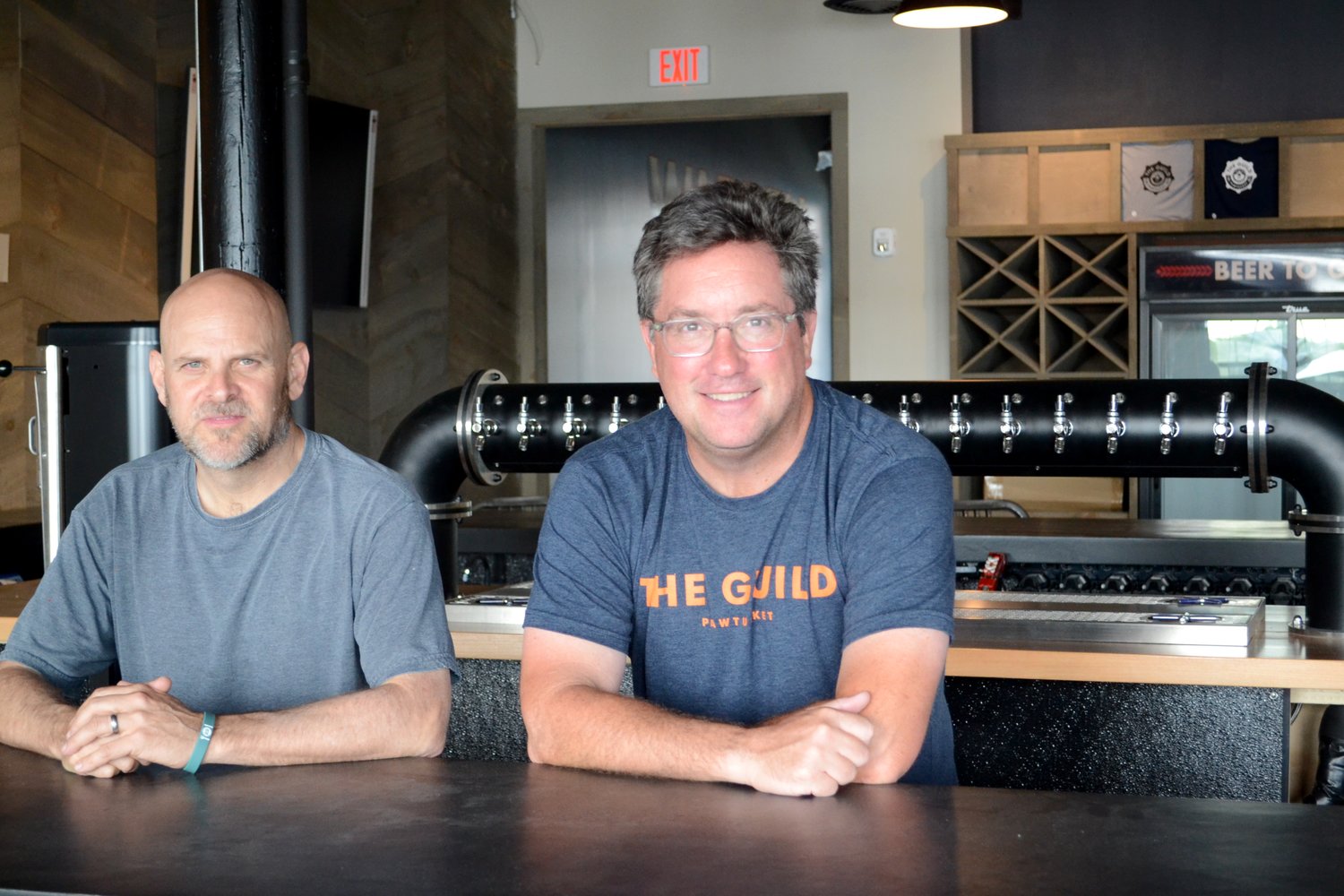 Jeremy Duffy (right), co-founder of The Guild, and Ed Levy, general manager of The Guild Warren, inside the new 140-seat brew pub on Water Street, which is set to open on Wednesday, Sept. 1