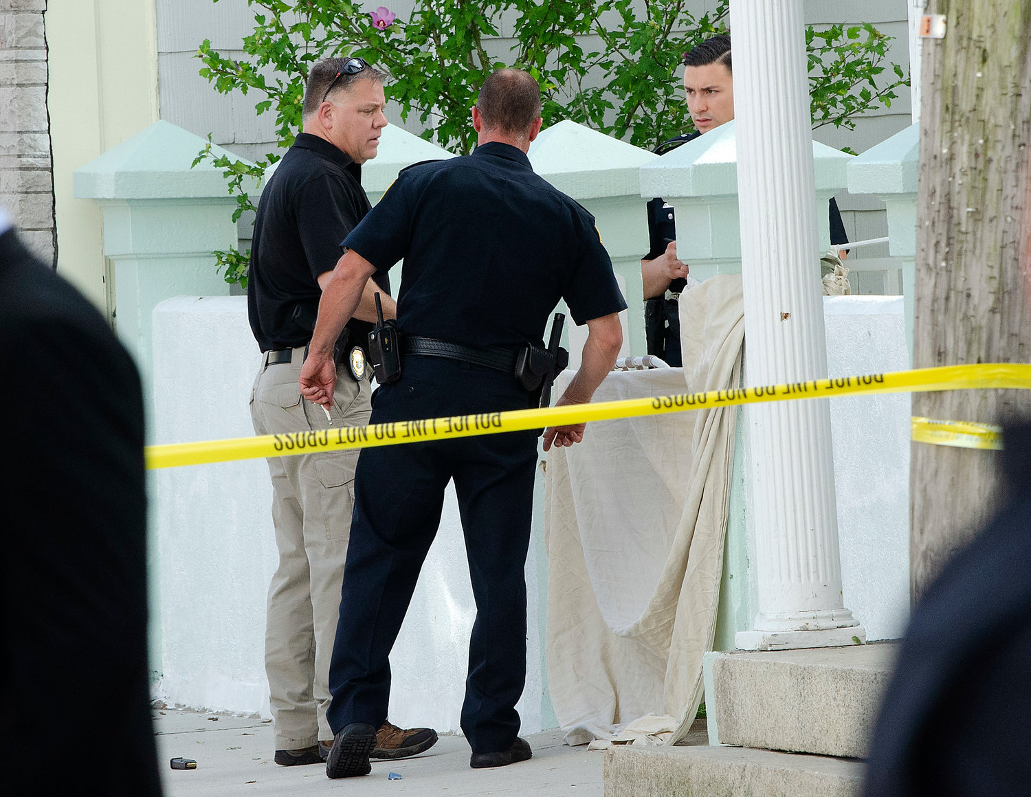 Warren police guard a shrouded body of a suspected shooter after an exchange of gunfire with police on Water Street.