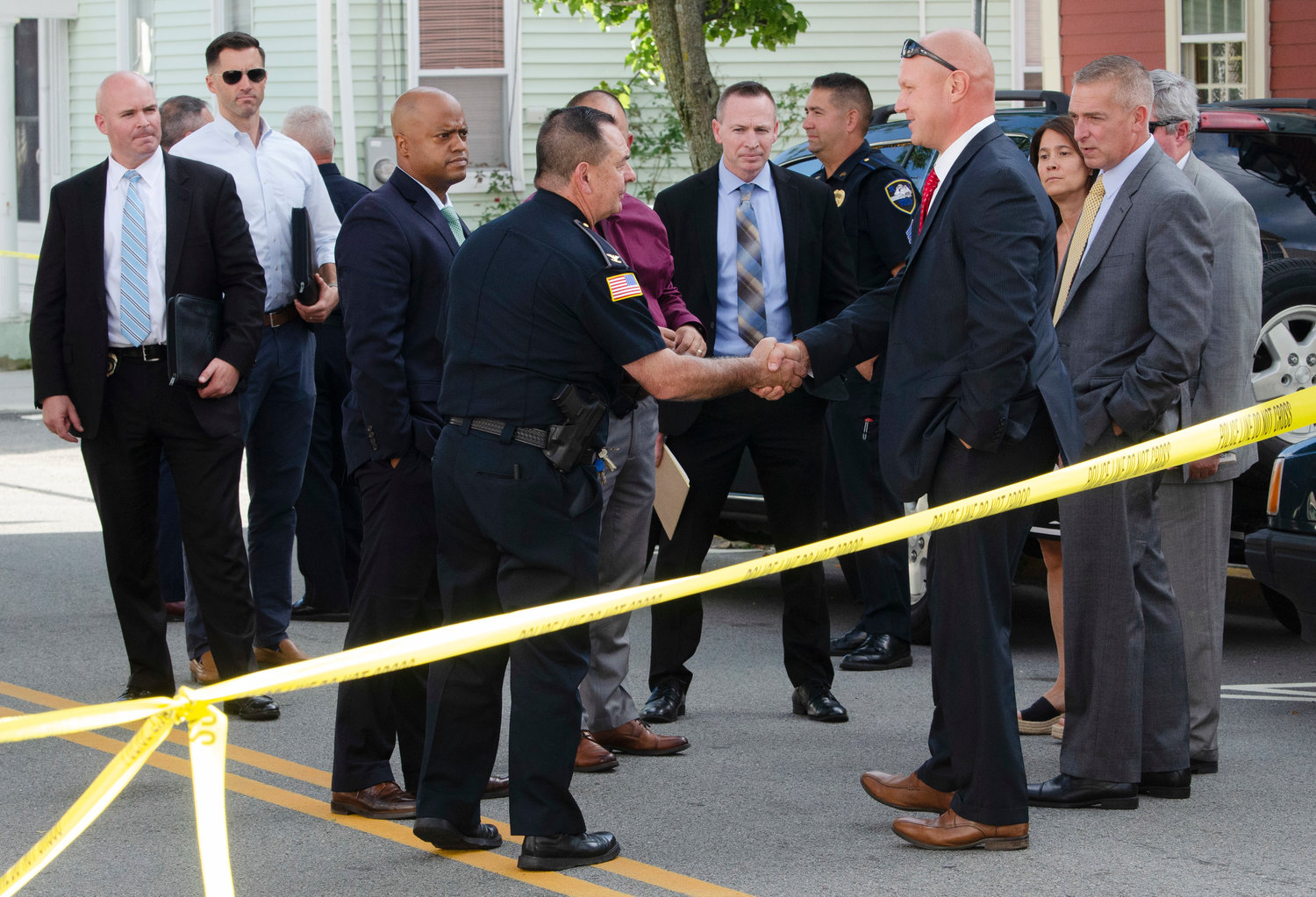 Warren Police Chief Roy Borges meets State Police officials at the scene of a shooting on Water Street.