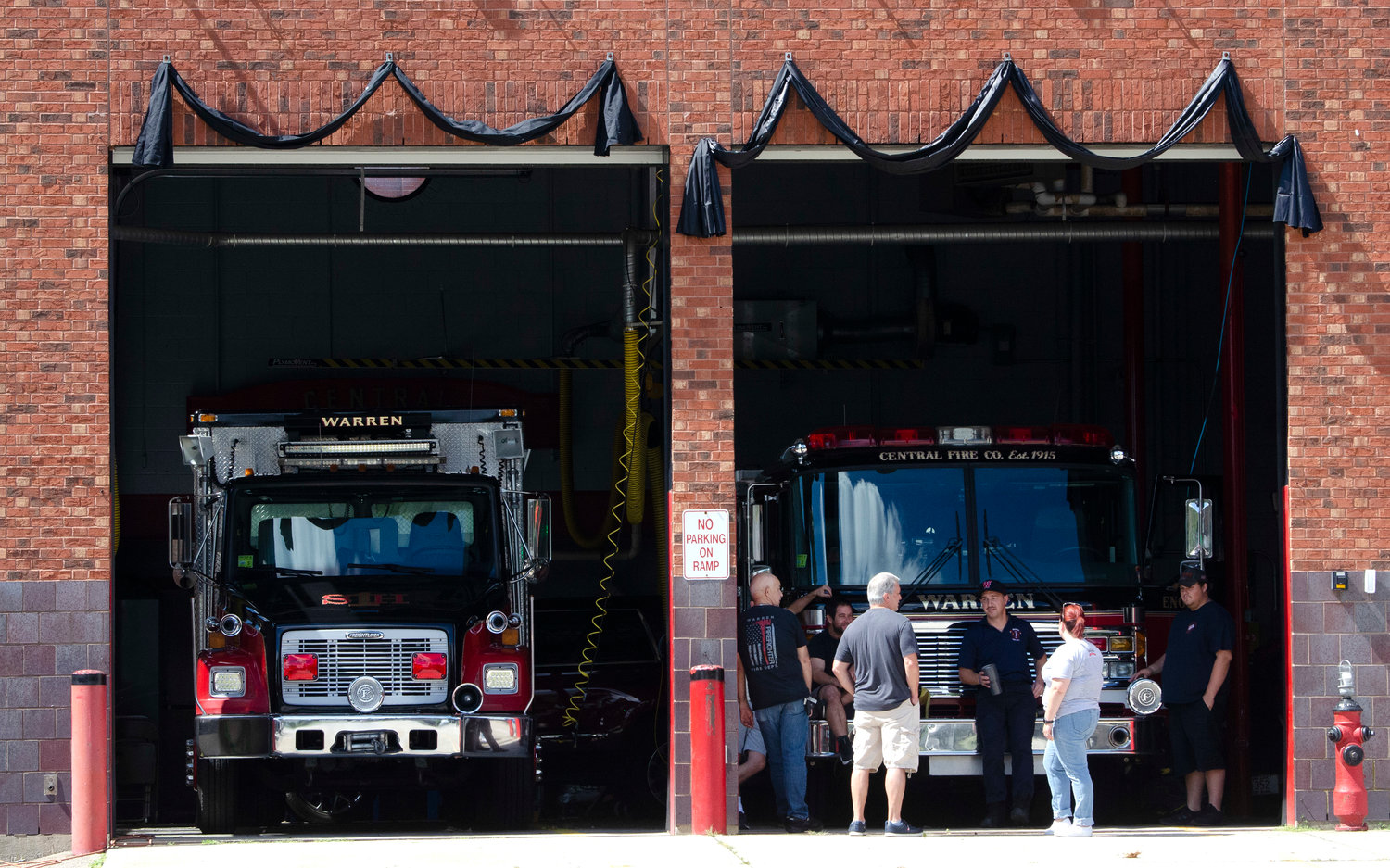 The Warren Fire Department hung a black banner in honor of the late Brian Remy at their headquarters on Friday morning.