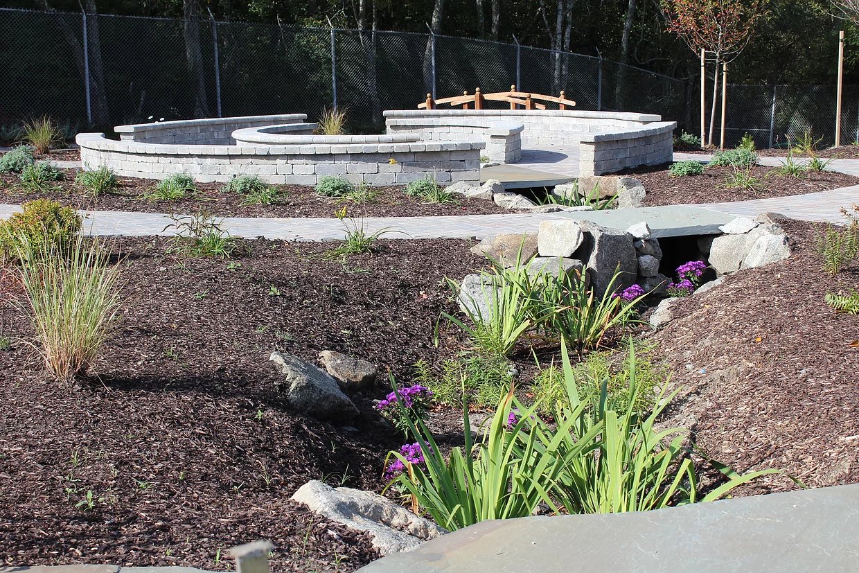 An outdoor learning space created by Thrive Outside at Melville Elementary School in Portsmouth shows the model the organization hopes to replicate elsewhere, with opportunities for children to explore nature and feel invigorated by time spent outside while in school.