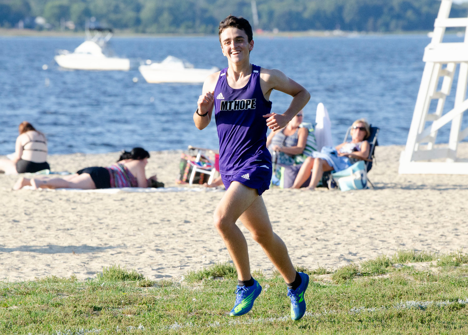 Mt. Hope senior Sam Merriam crosses the beach towards the finish line leading the 25 man field. he placed first with a time of 18:40.