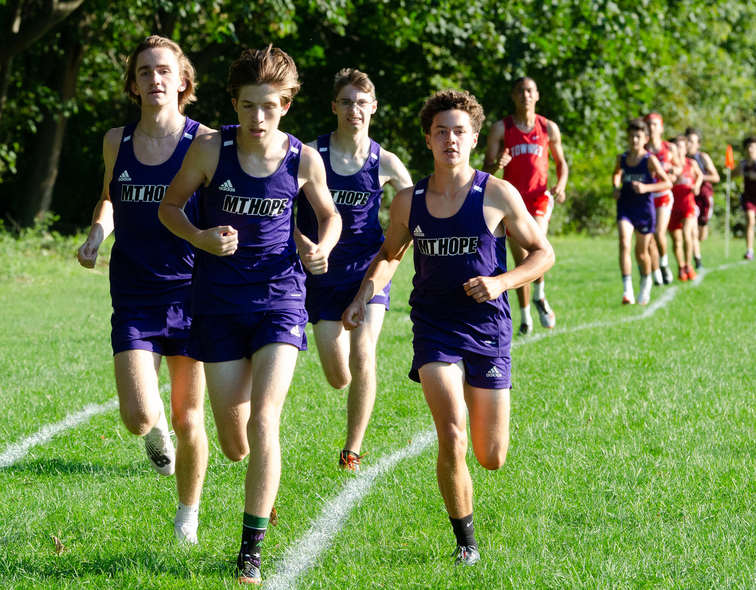 A pack of Huskies from left, George Piper, Owen Schenck, Declan Reed and Josh DeWolfe, race across the field.