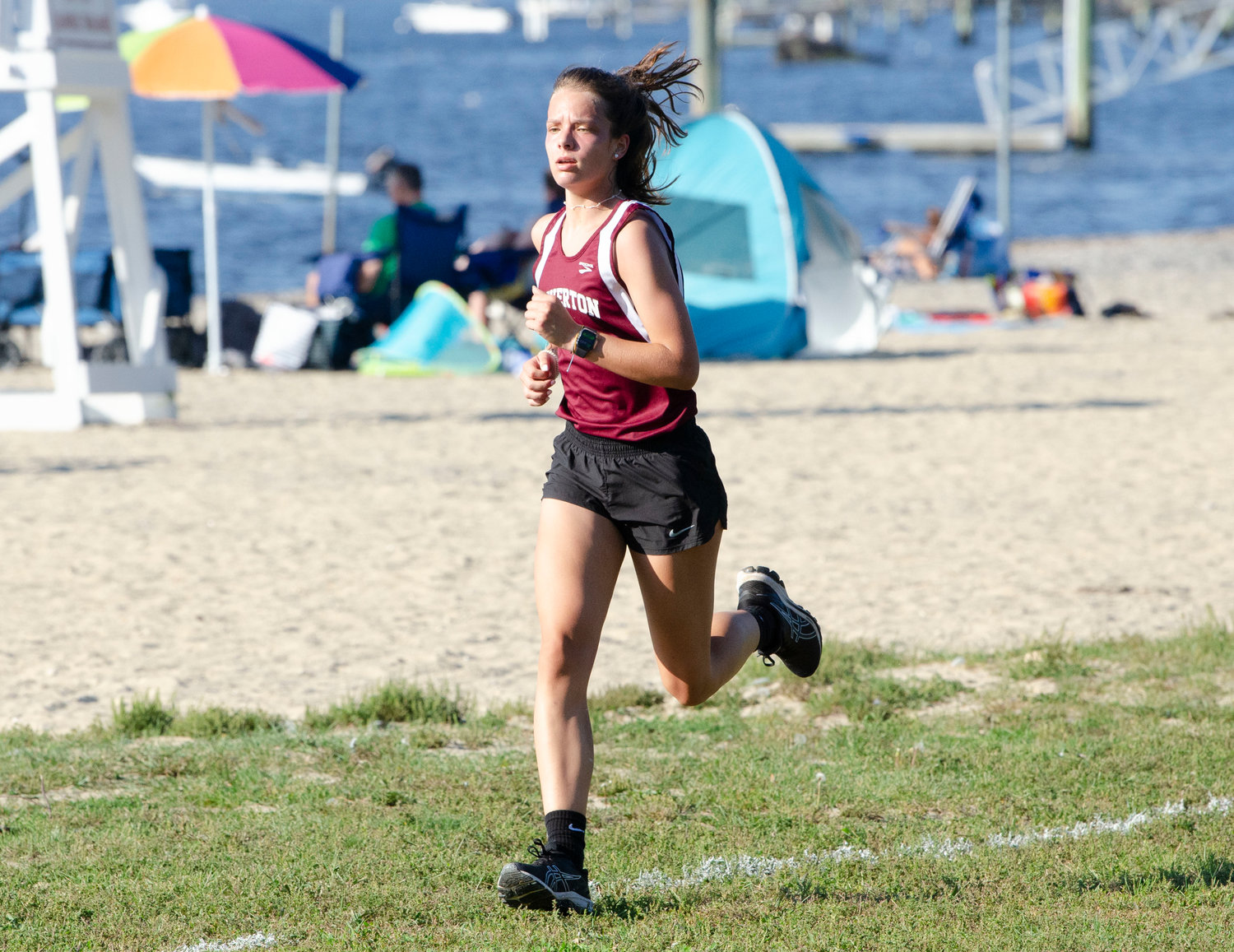 Tigers freshman, Ellery Pacheco, races along the beach to the finish line. Pacheco placed second during the cross country meet in Bristol on Monday September 13th.