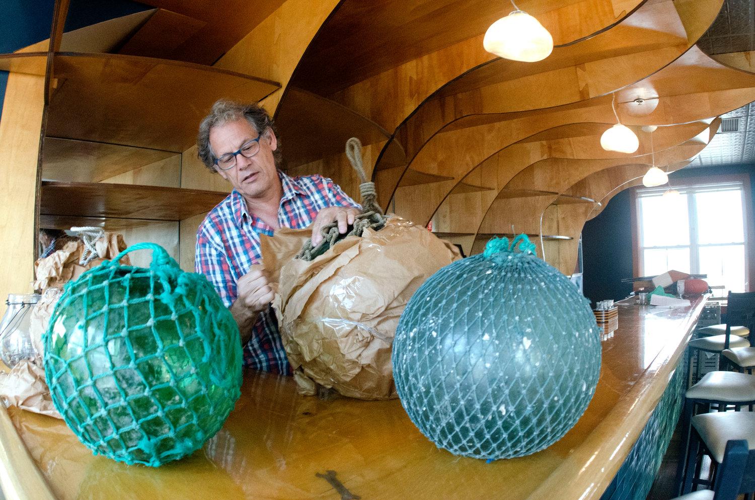 Russell Goyette unwraps new decor fixtures during a tour of the newly renovated restaurant.