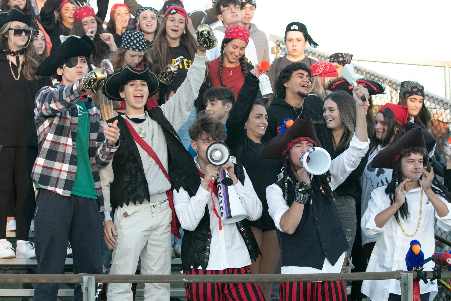 Ben Flynn (bottom left), Chris Frawley, Josh DeWolf and the Huskies ‘Dog Pound,’ cheered on the soccer team donned in pirate gear, prior to the football game that started at 7 p.m.