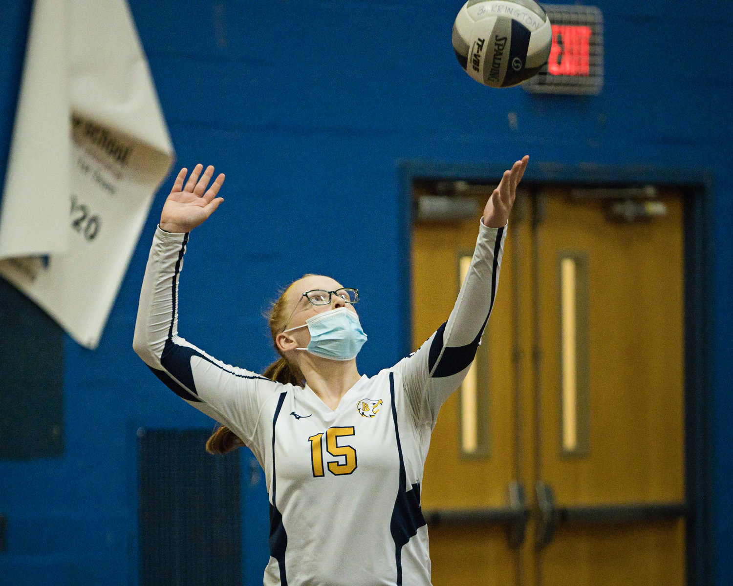 Nellie Peecher serves the ball to Rogers during the second set of 
Monday's match.