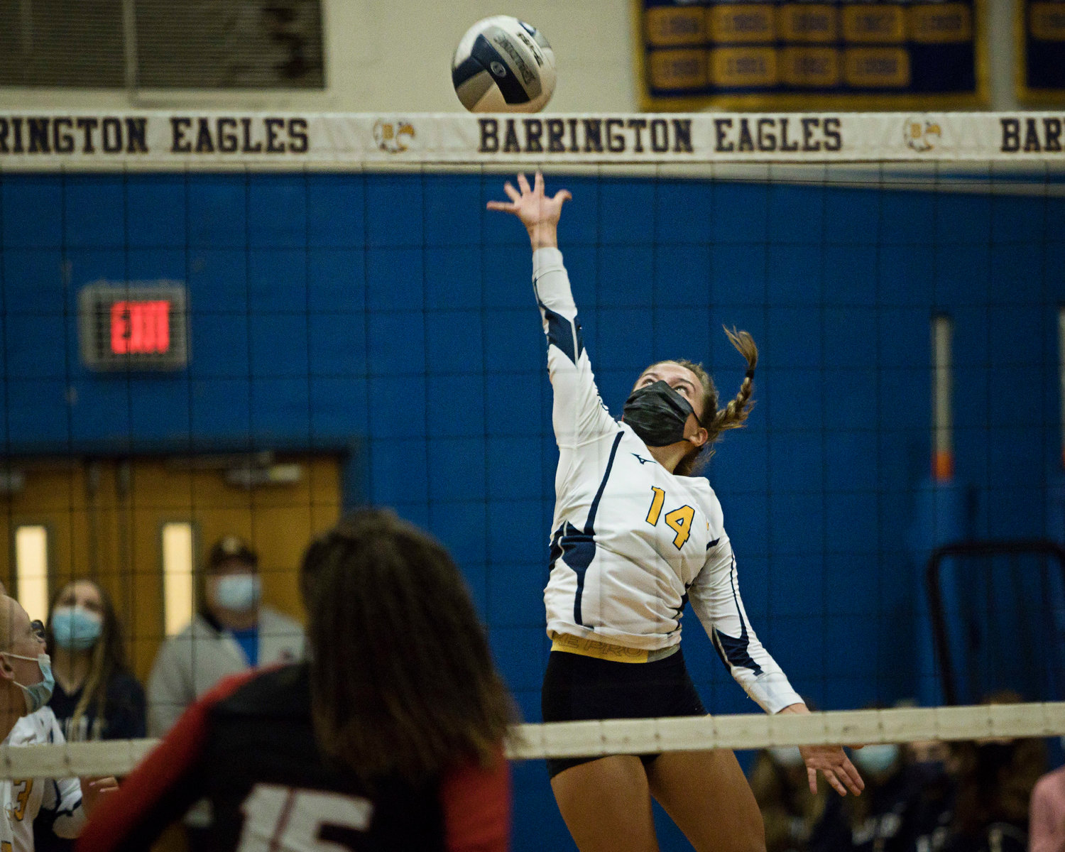 Tessa Sullivan spikes the ball over the net while rallying with 
Rogers, Monday night.