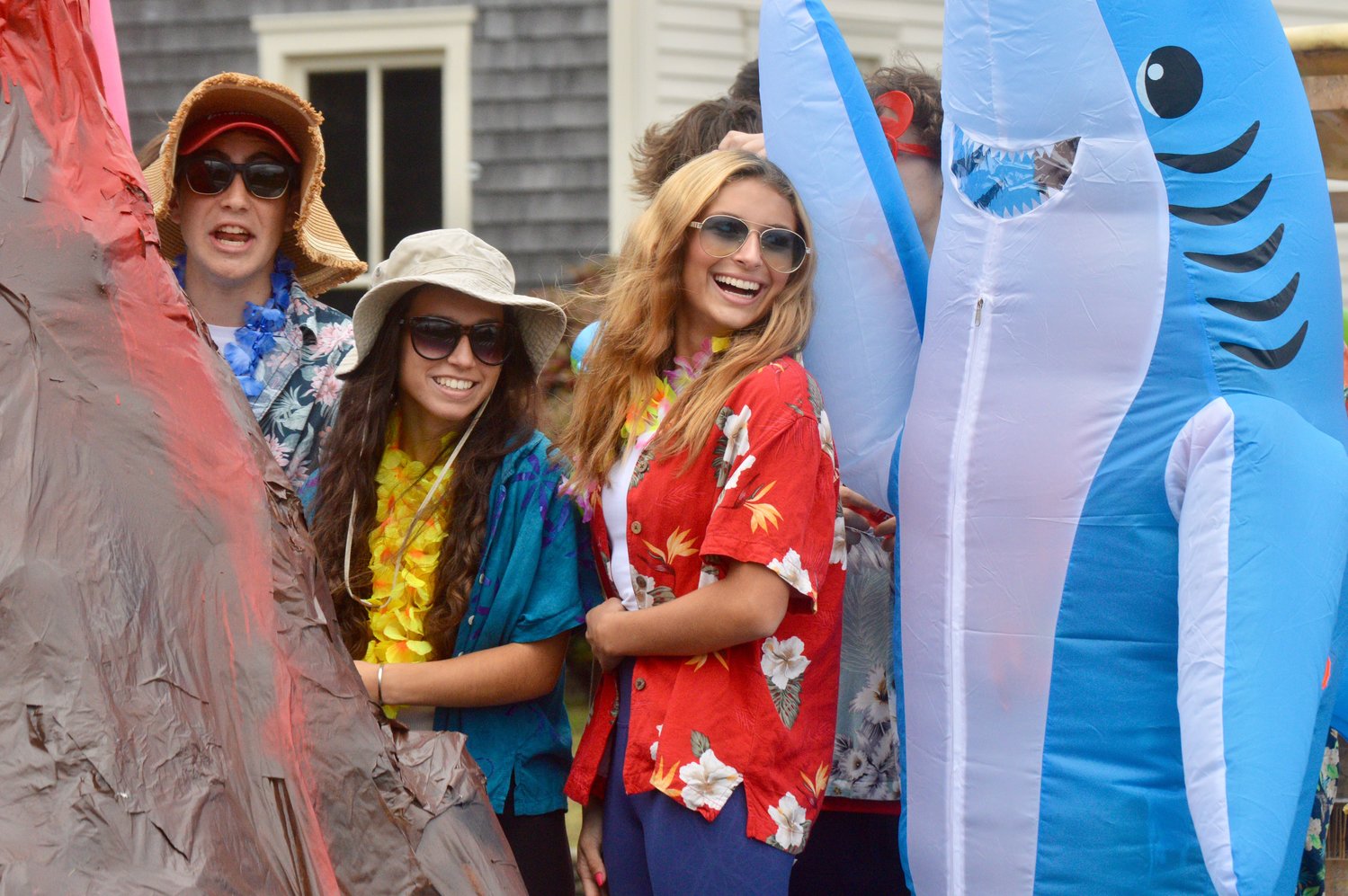 Taylor Barnaby, Sophia Sousa, Emily Desrosiers (in shark costume) and Elliot Abong greet parade-goers along East Main Road.