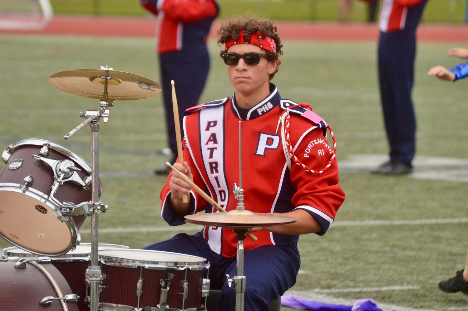 Nate Levine accompanies the marching band on drums during the halftime show.