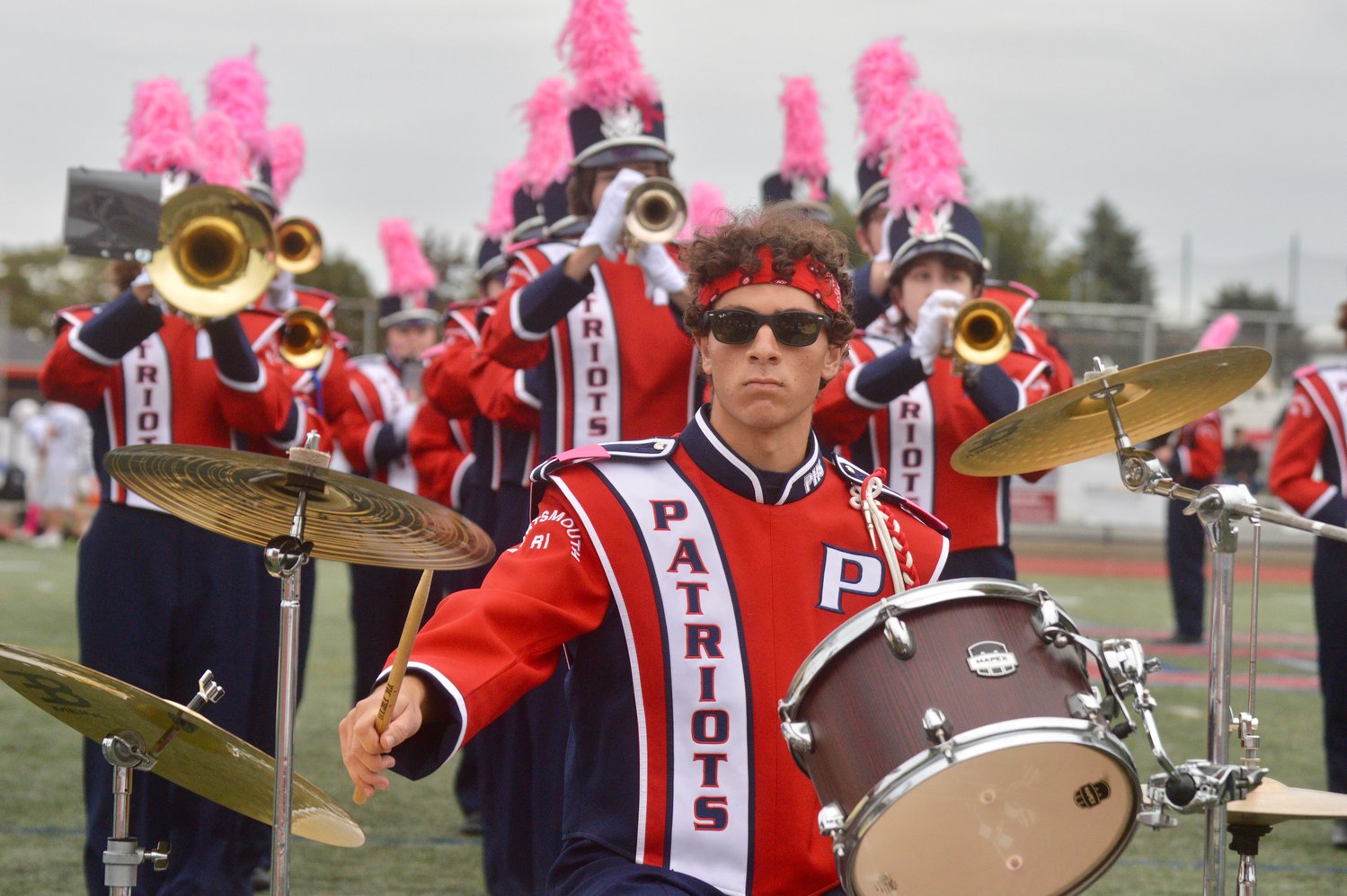 Nate Levine accompanies the marching band on drums during the halftime show.