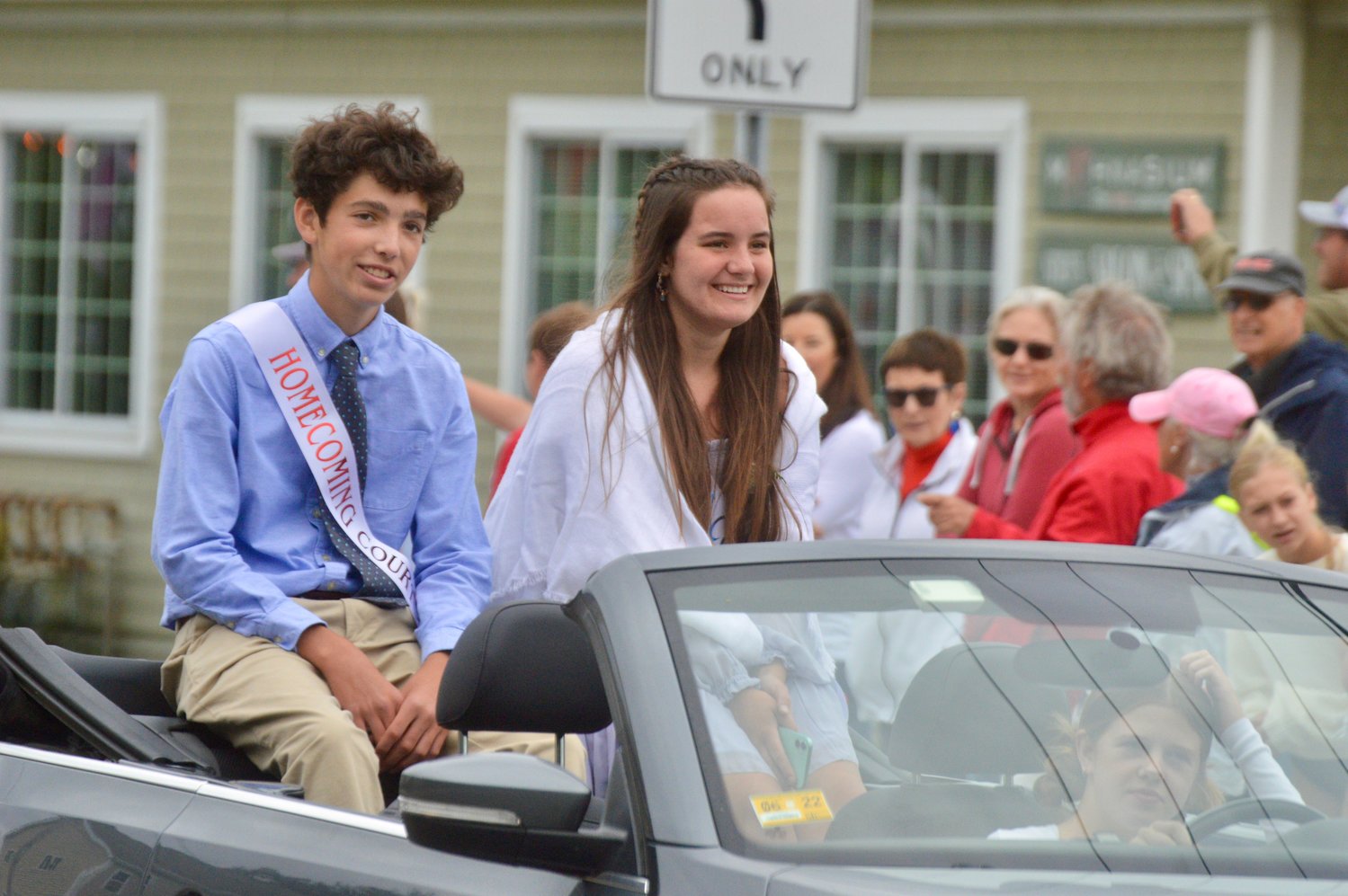 Ronan Caulfield and Ashley Sullivan of the Homecoming court greet spectators during the parade.