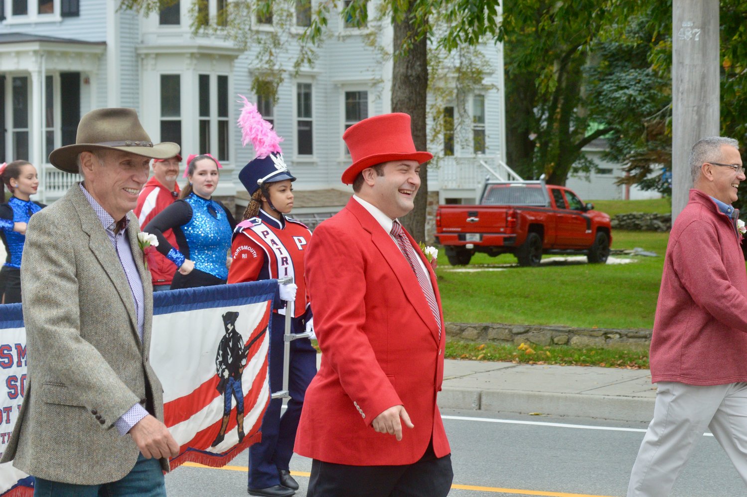 Tom Vadney of the School Committee and Andrew Kelly and Kevin Aguiar of the Town Council (from left), greet spectators during the parade.