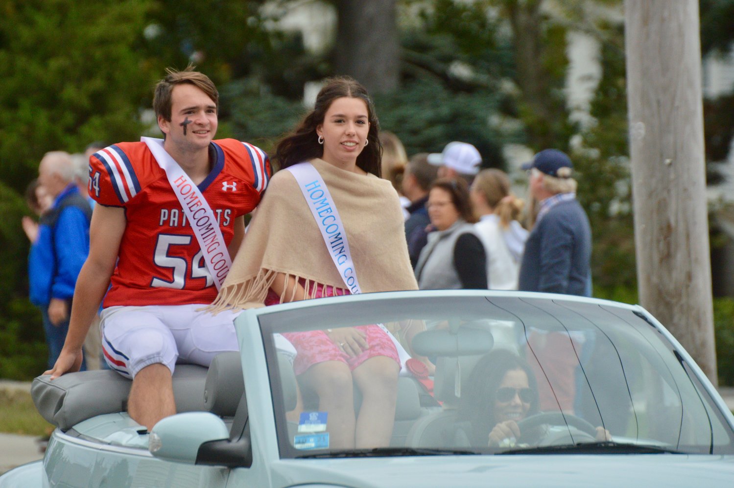 Will McKinnon and Mia Bartlett of the Homecoming court greet spectators during the parade.