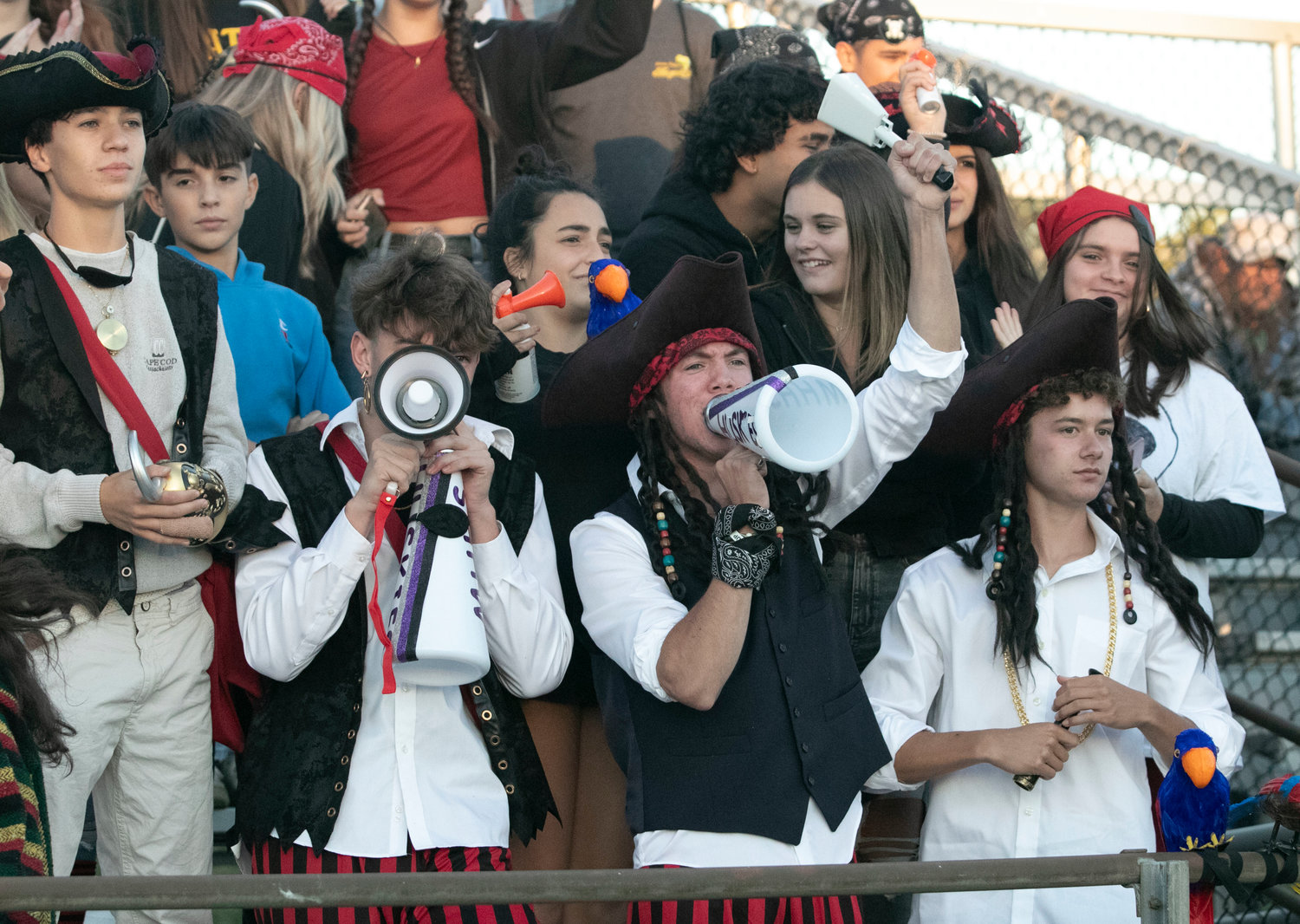 Some parents have questioned why students can play sports, gather for raucous celebrations in the student cheering section known at the “Dog Pound,” as seen here during a home football game earlier this month, but not be allowed to attend a Homecoming dance this weekend.