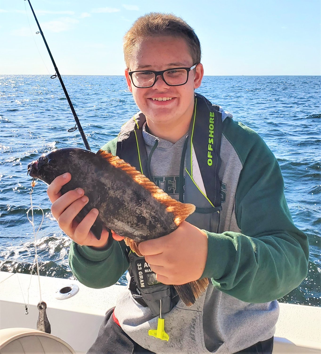 Strong tautog bite: Blake Webster with one of the tautog to 20” that he and his family caught off Newport this week.