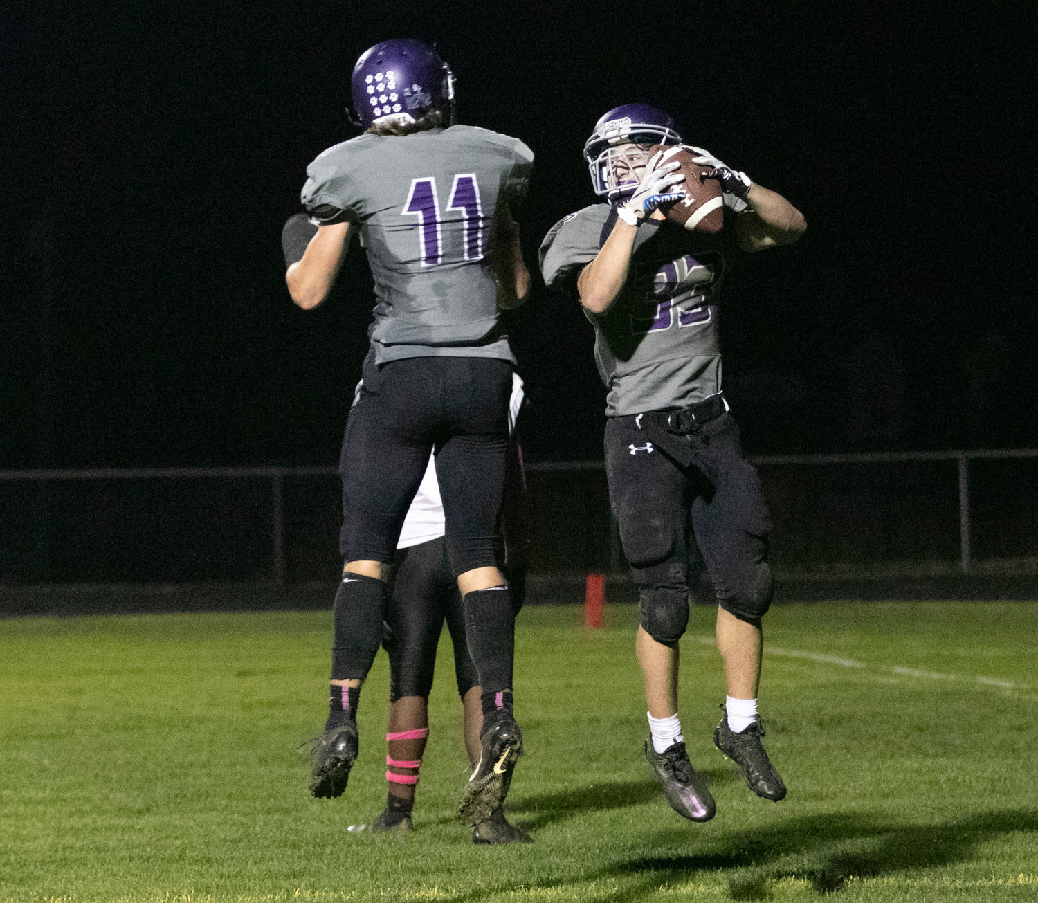Bruce McGuire (left) celebrates with Brock Pacheco after he scored the Huskies first touchdown in the first quarter.