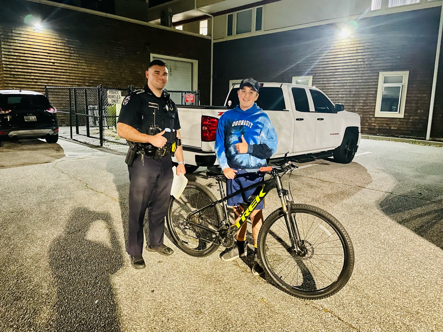 Barrington Police Officer Brendan Combes reunites Barrington resident Brandon Medeiros with his bicycle, which had been stolen last Wednesday.