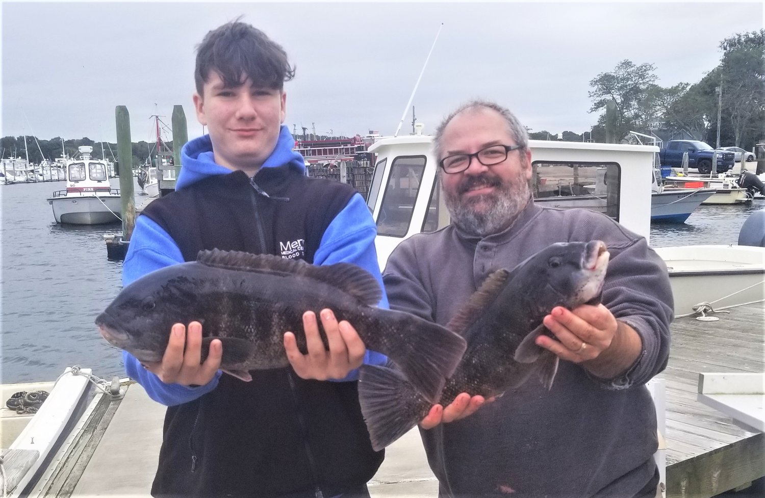 Tautog bite very good: Andrew Stevens with his father Jim Stevens of Warwick with the tautog they caught Saturday at General Rock in North Kingstown. It was the first time Andrew had been tautog fishing.