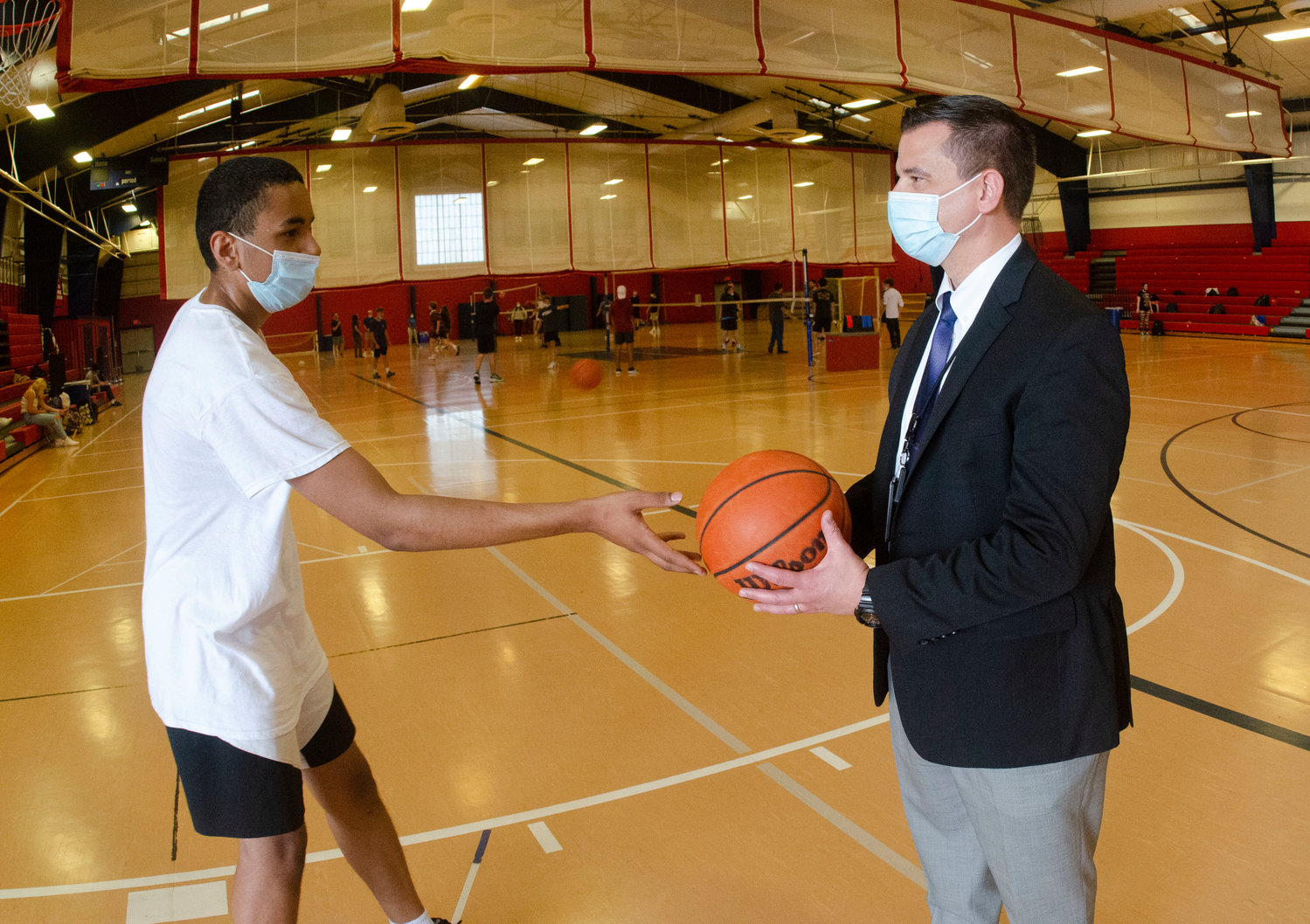Darin Grady, a junior at Portsmouth High School, chats with Superintendent Thomas Kenworthy inside the field house during a recent gym class. The school district wants to install air conditioning in the building so that the floor is safe during the warmer months, and to prevent rusting of the exercise equipment upstairs.