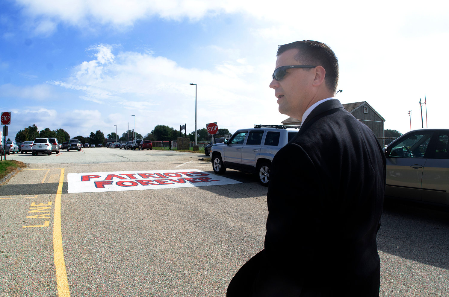 Superintendent Thomas Kenworthy stands on Memorial Drive, which is owned and maintained by the School Department.  “It’s definitely a safety concern,” he said. “The plan would be to widen it, put full sidewalks in on both sides, and refinish it.”