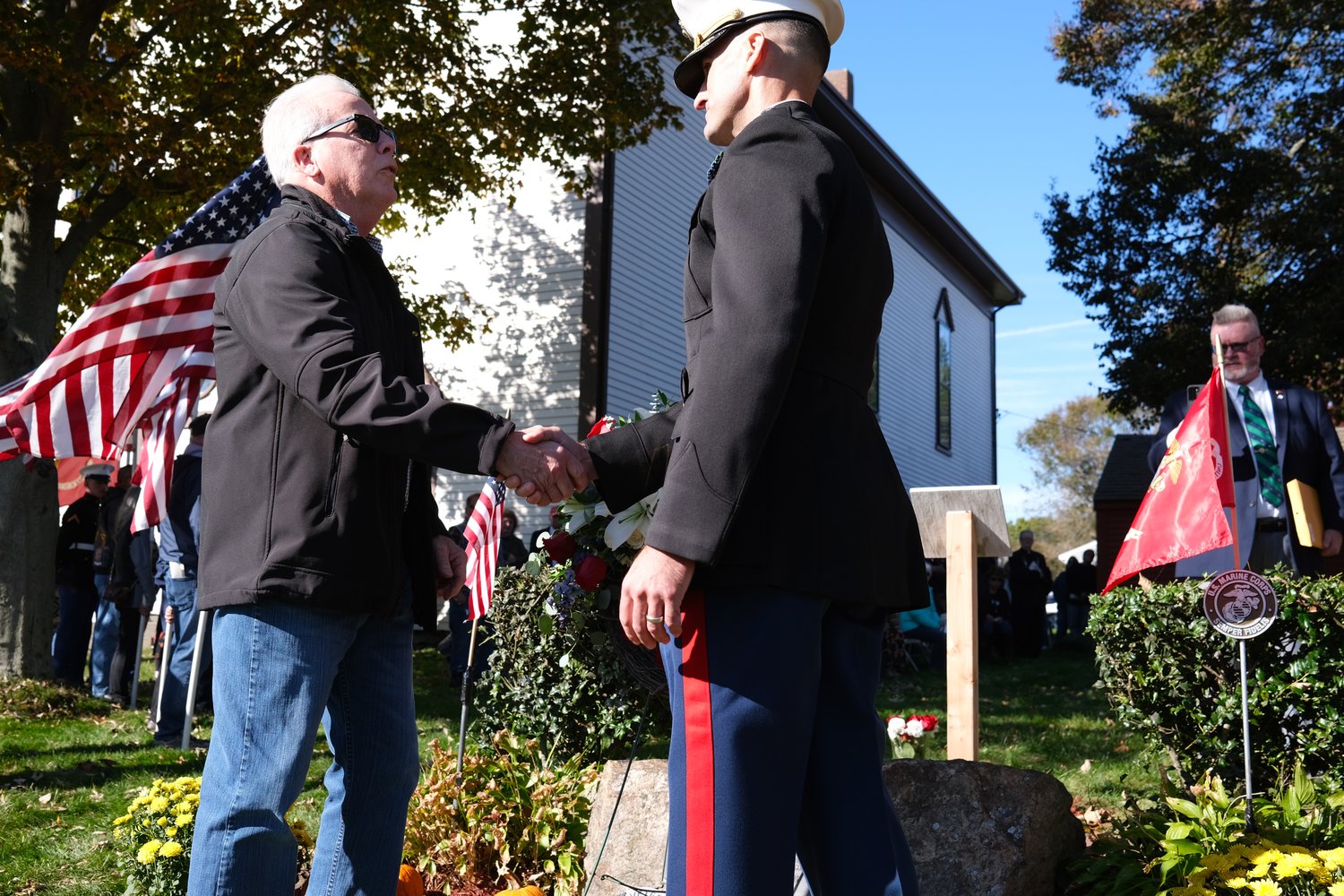 Billy Giblin (left) shakes hands with Lt. Col. Scott Stephan after they placed a wreath by the memorial to the “Rhode Island Nine.” Giblin is the brother of the late Sgt. Timothy Giblin, who was memorialized for his sacrifice in the Beirut barracks bombing of 1983.