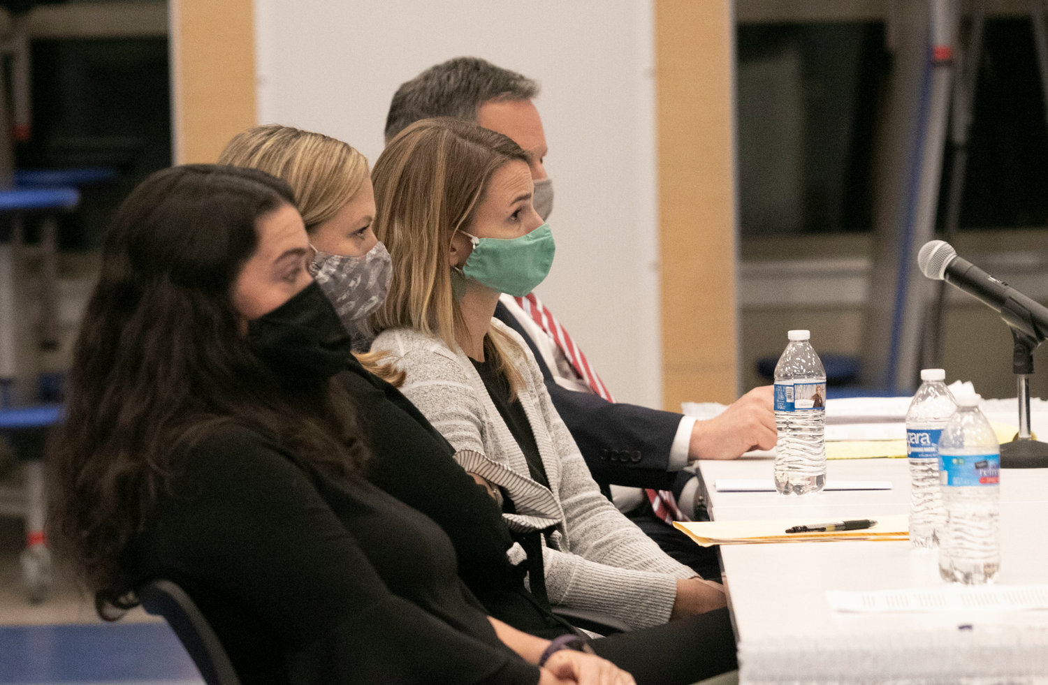 Barrington teachers Kerri Thurber, Brittany DiOrio, and Stephanie Hines (from left to right) sit with their attorney, Greg Piccirilli during Thursday night's pre-termination hearing.
