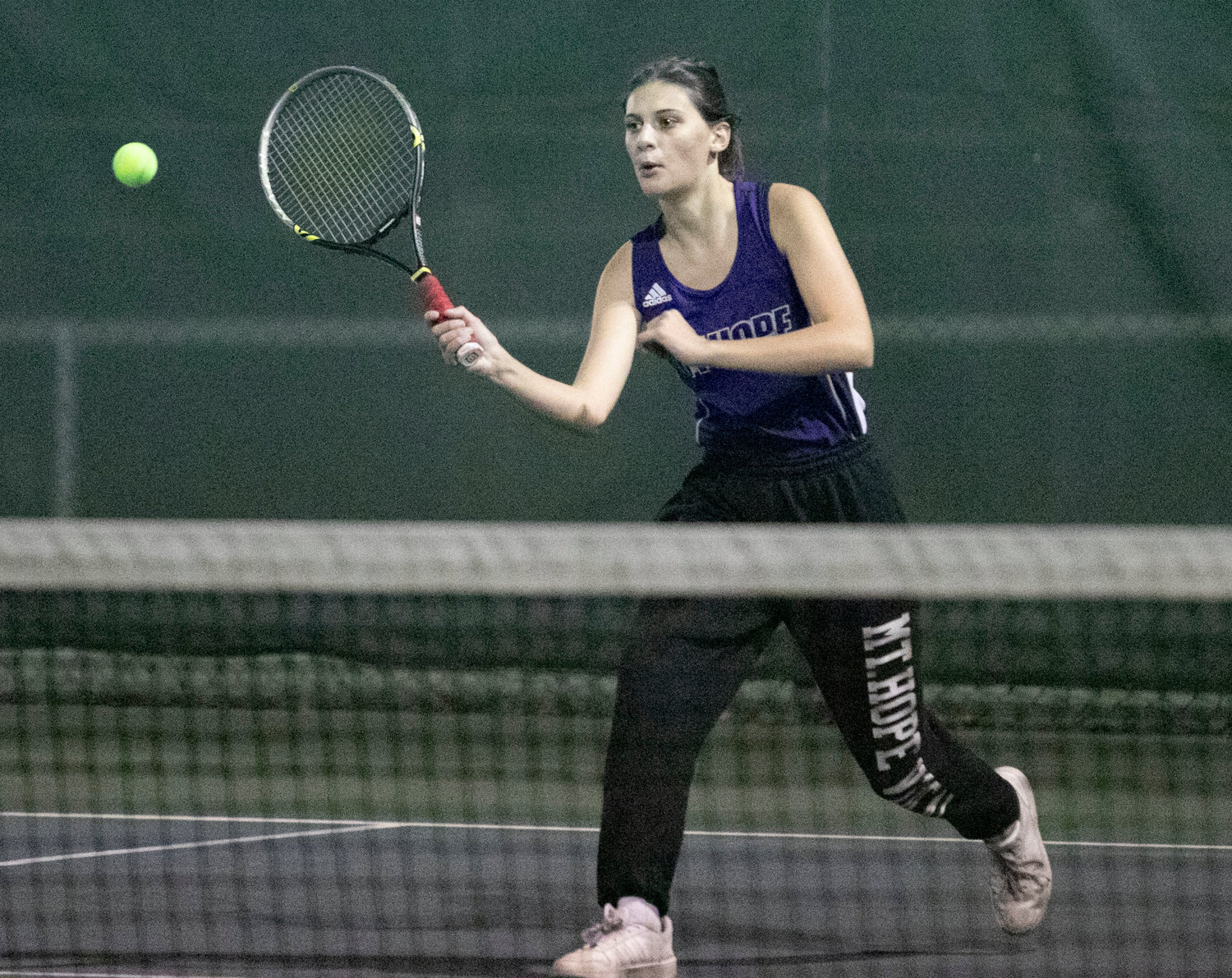 Emily Marino volleys a shot for a winner during the first doubles match.