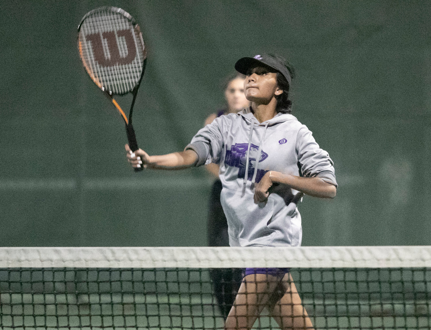 Aditi Mehta slams a shot by her opponents for a winner in the second set of the first doubles match.