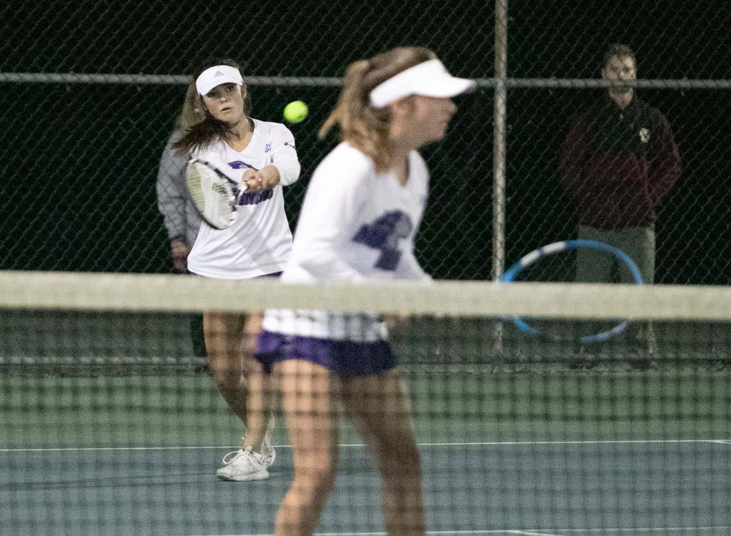 Zelda Hayes hits a backhand during the match, with parterner, Laney Dufficy at net.
