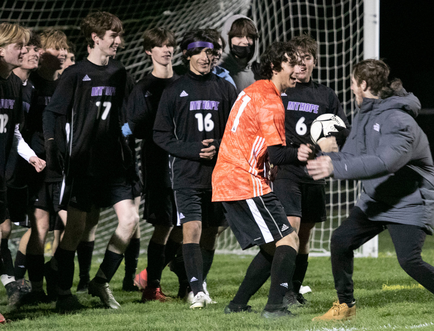 Goalkeeper Matt Terceiro (middle) and teammates celebrate with Jake Marshall after the game.