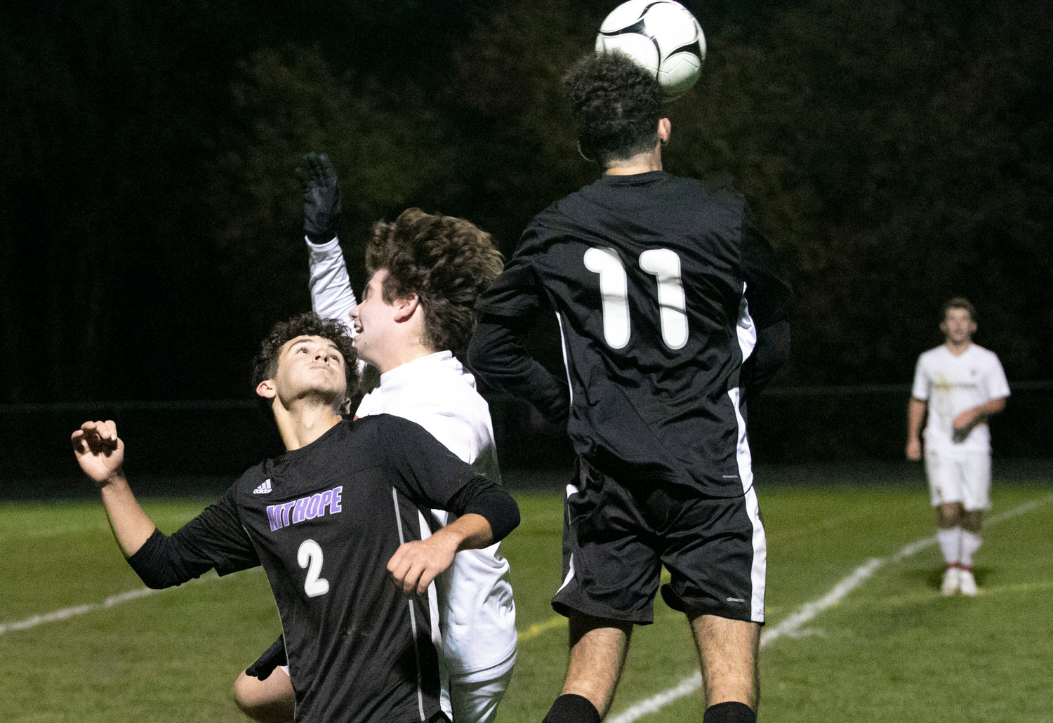 Parker Camelo (left) looks on as teammate Noah Furtado puts his head on a throw in.