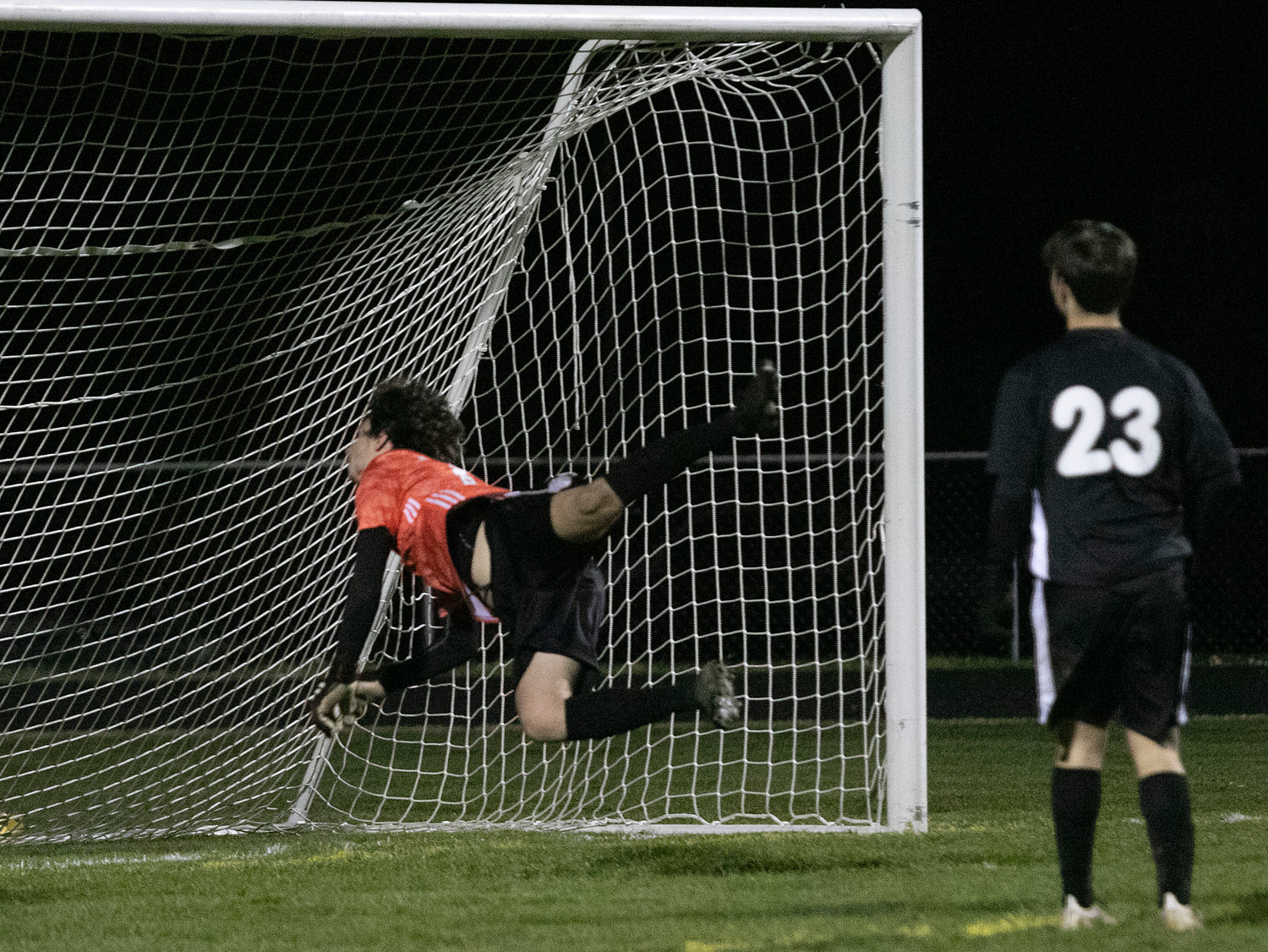 Terceiro falls back after punching the ball over the net for a save in the second half.
