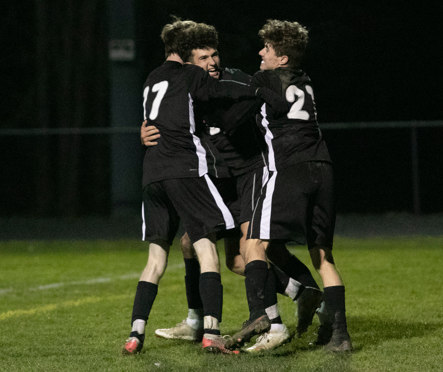 Dylan Brol (left) and Justin Mendes (right) give Parker Camelo a big hug after he scored to give Mt. Hope a 2-0 lead in the second half. The Huskies went on to beat Cranston West, 3-0 and move on the the semifinals.