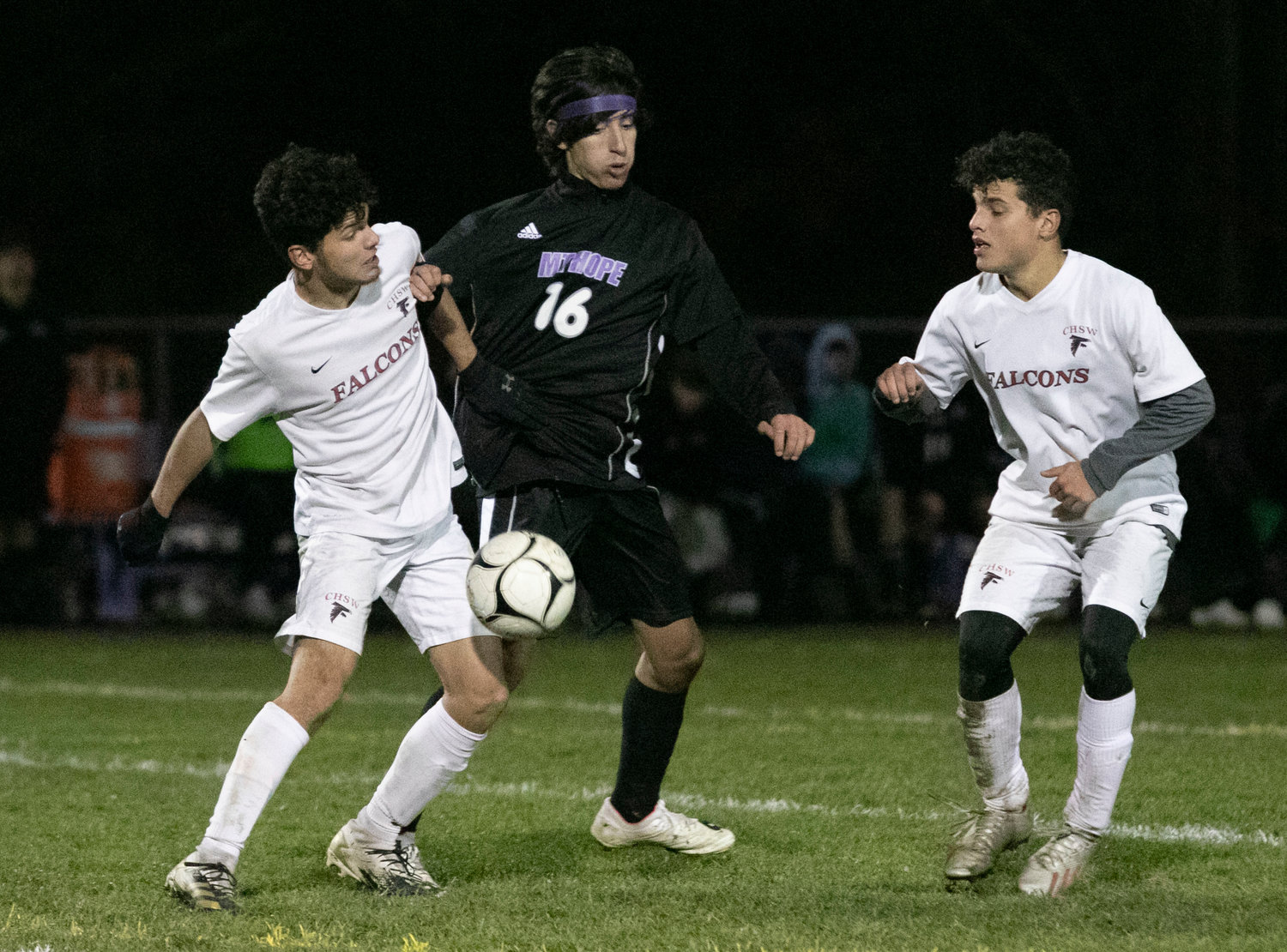 Defender Phil Berrettp (middle) vies for the ball at midfield.