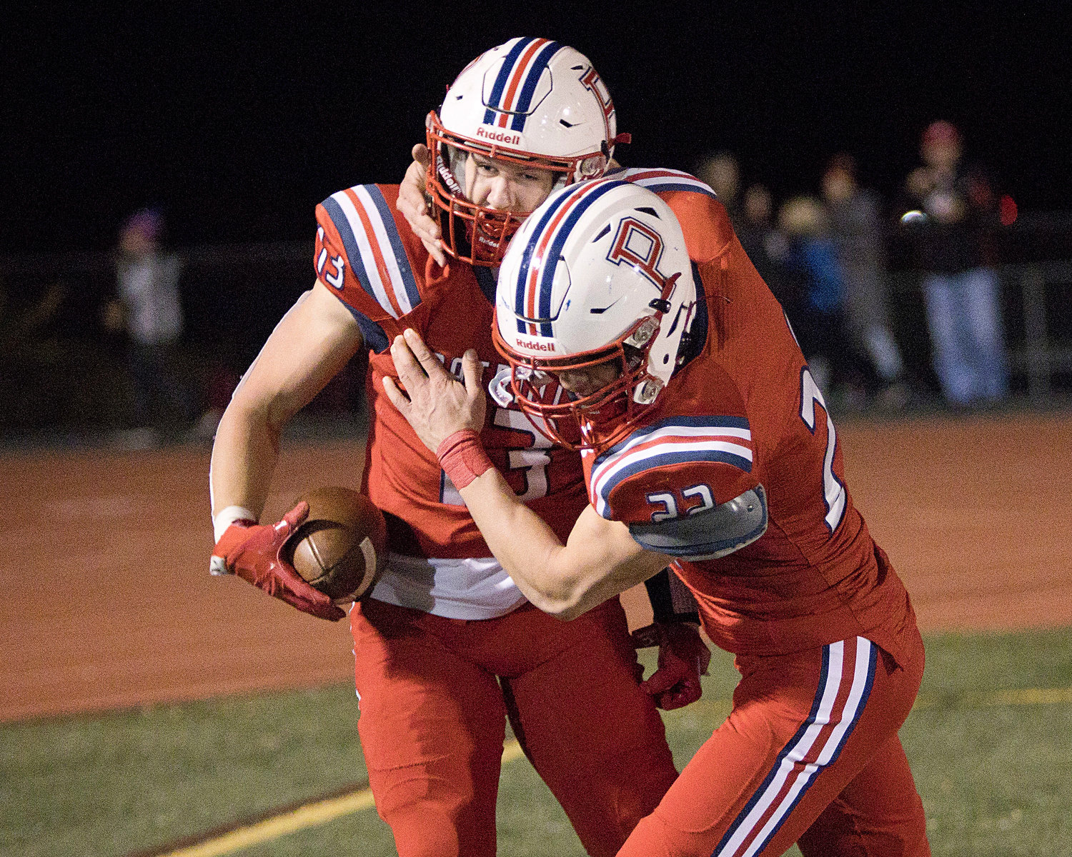 Evan Beese (left) and Thomas McGraw celebrate a touchdown while competing against Shea in round one of the Division I playoffs, Friday.