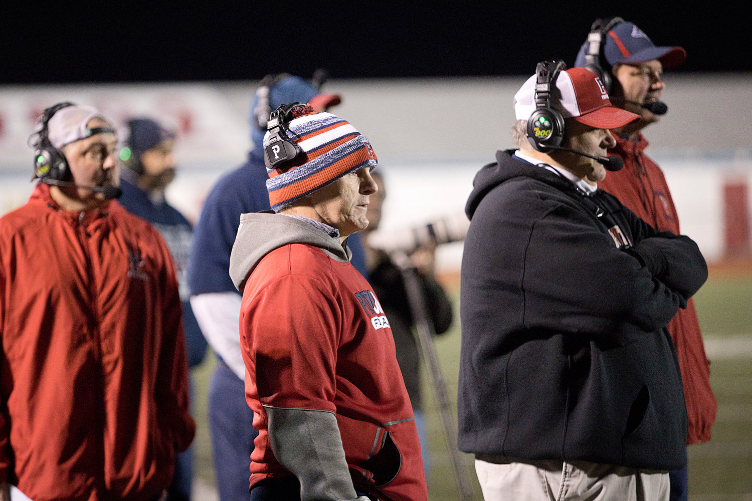 Head coach Dustin Almeida (center) looks on with the rest of his staff on Friday night.