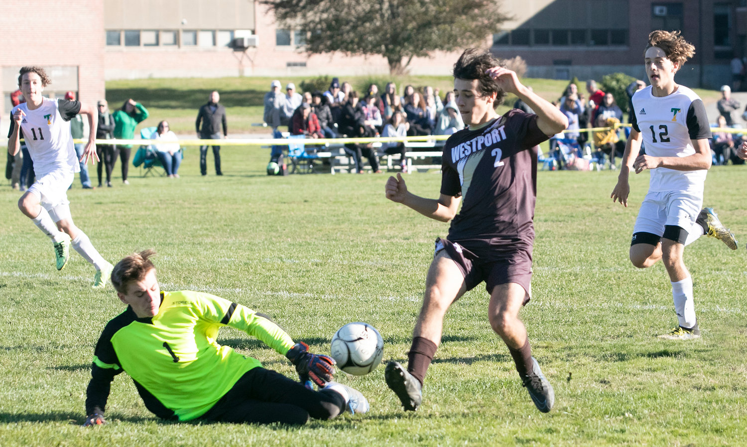 Striker Hunter Brodeur dribbles over Braves goalkeeper Tim Parsons and taps the ball into the net for his second goal of the game to give Westport a, 3-0 lead in the second half.