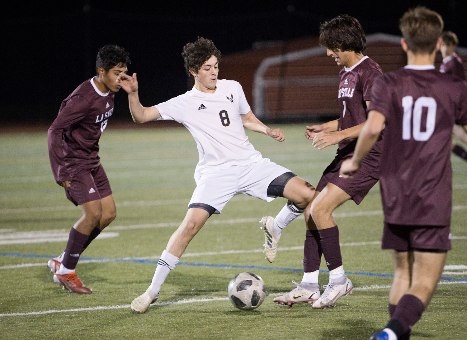 Barrington's Ryan Perugini is pressured by a trio of LaSalle opponents while taking possession of the ball.