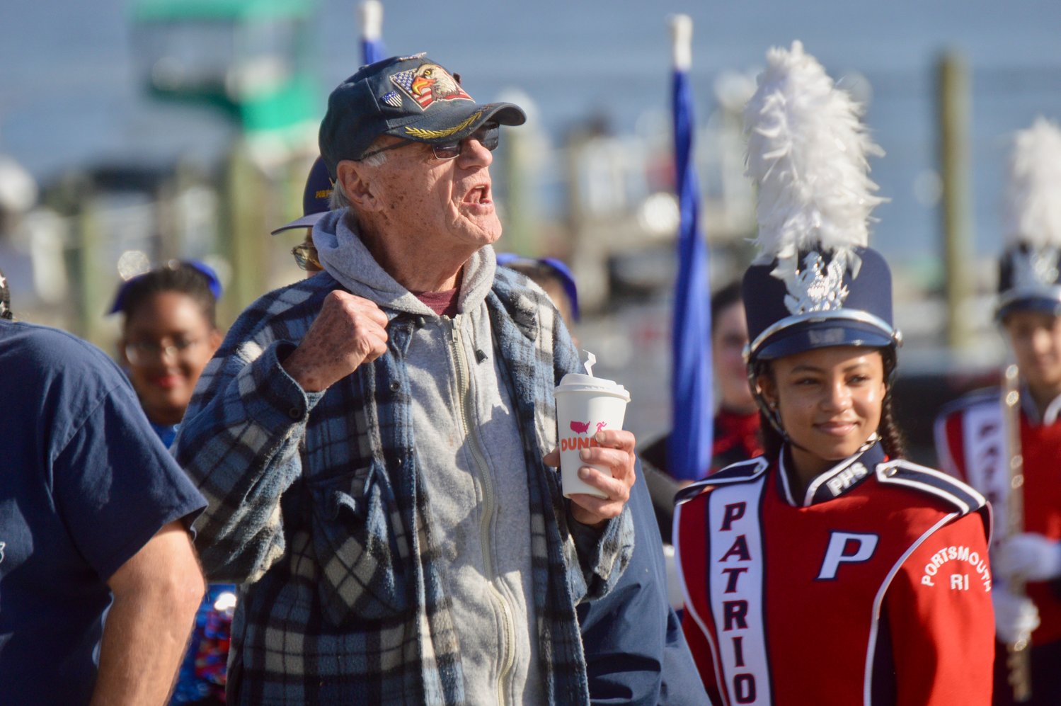 George Cushman, 90, loudly implores fellow veterans to join him in leading a brief parade from Teddy’s Beach to Thriving Tree Coffee House last Thursday. The PHS Marching Band turned out to pay tribute at the Veterans Day event, in which military personnel were offered free food and entertainment at the restaurant.
