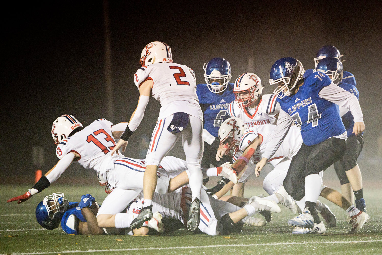 Marcus Evans (6) and Evan Beese (13) tackle a Cumberland opponent near the 50-yard line.
