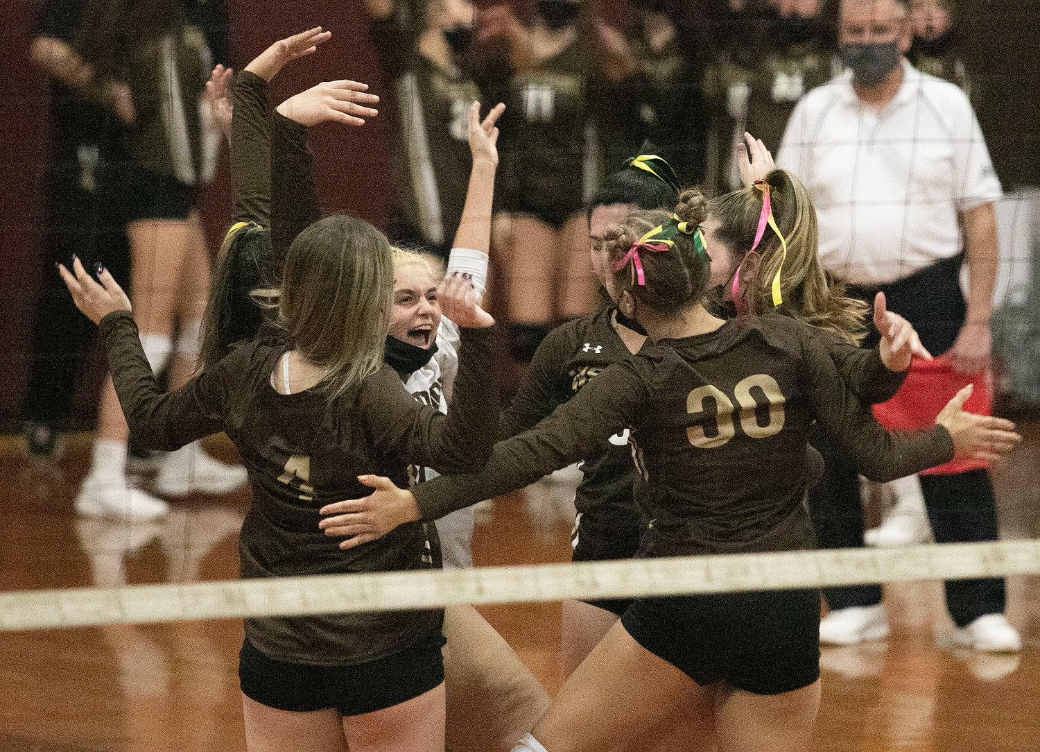Paige Churchill (left) leads the cheer after a Wildcats ace.