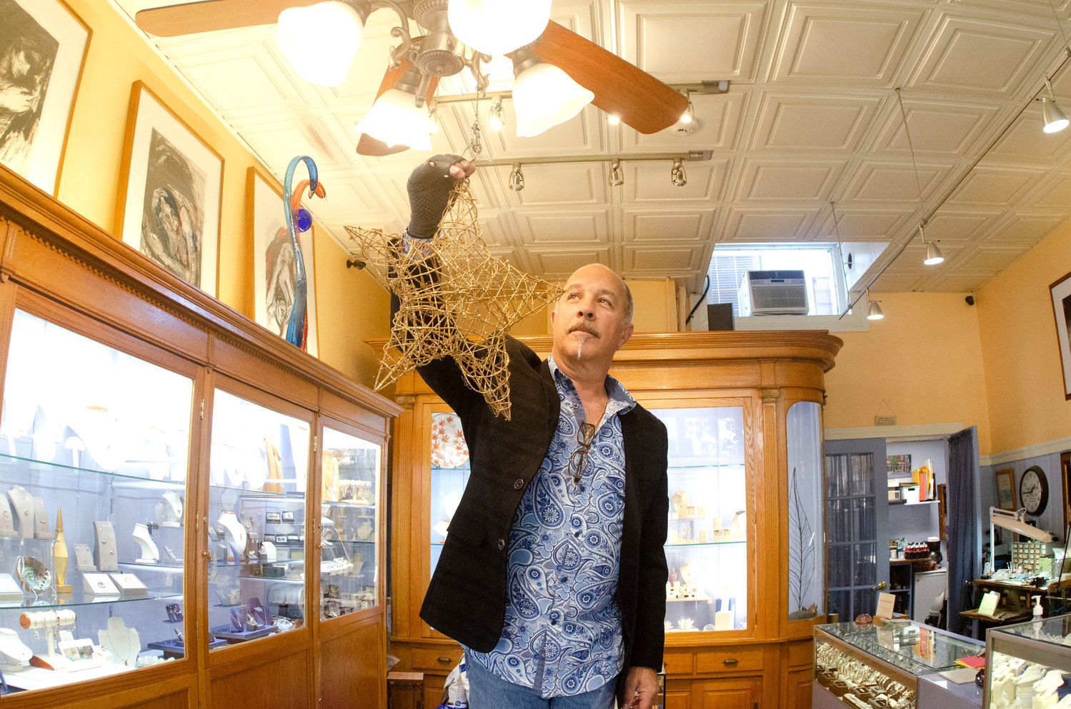 Joe Caron of Caron’s Jewelers makes preparations for Friday night’s Holiday Preview and the kickoff of the Snowflake Raffle. The Preview will be held Friday from 5 to 9 p.m.; follow the luminaries to participating businesses.