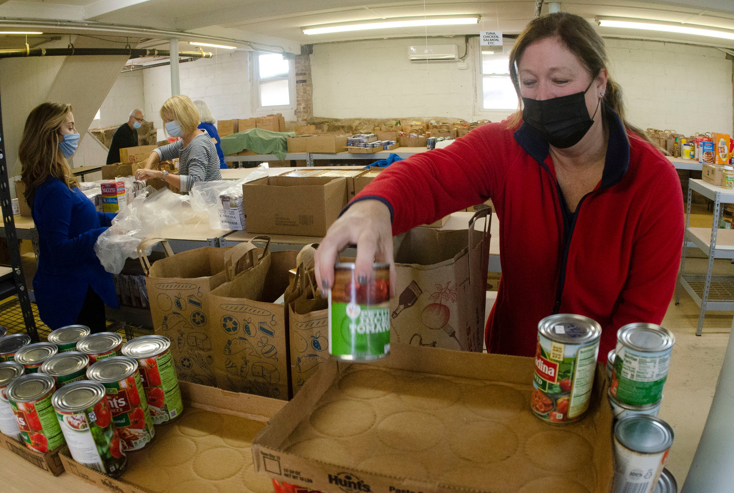 Dana Stewart, Westport food pantry director, helps out at the Grange hall Friday morning.