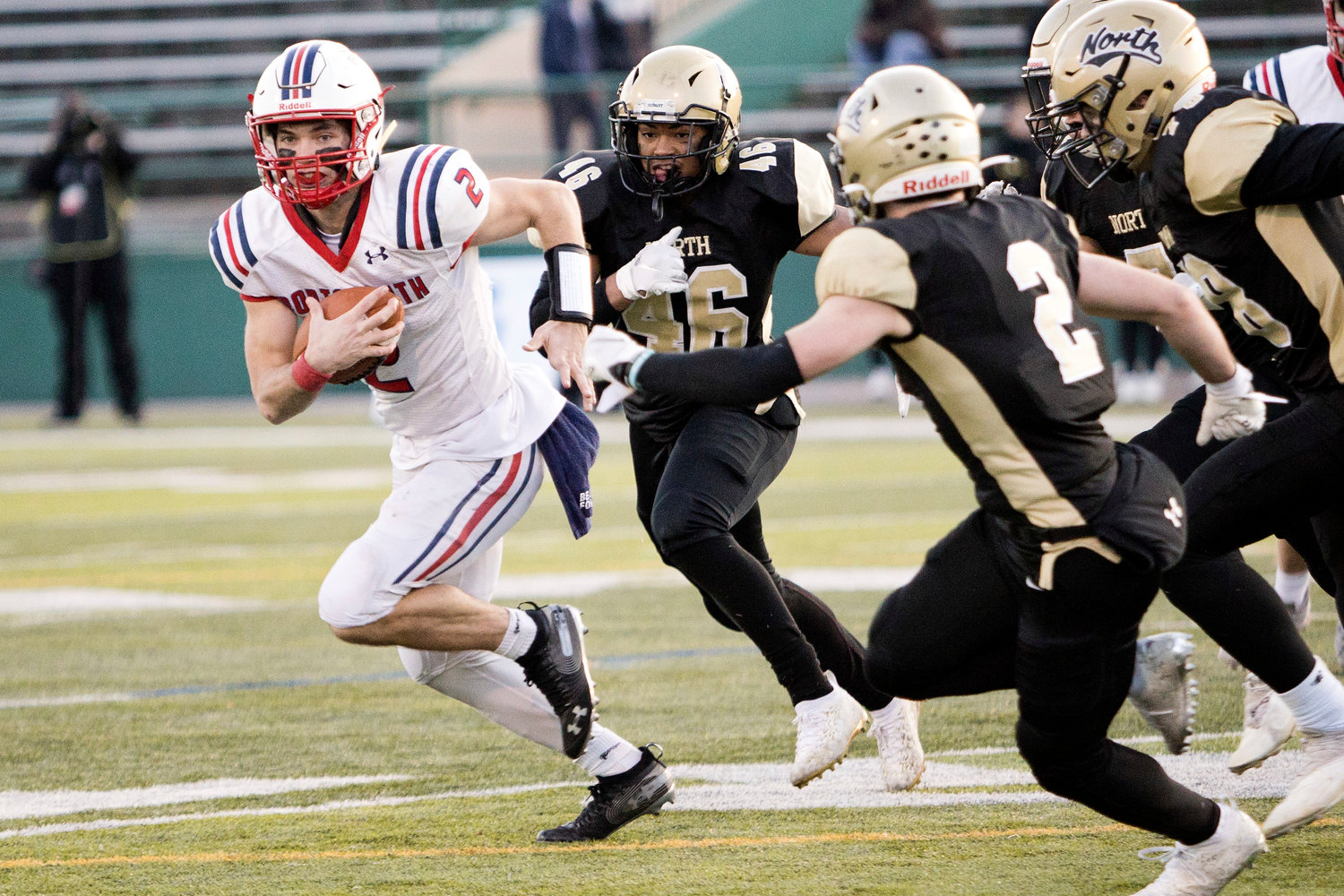 Benny Hurd runs away from the North Kingstown defense while carrying the ball for Portsmouth.