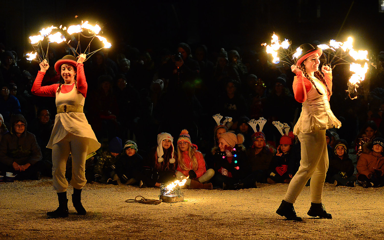 Fire dancers captivate an audience.