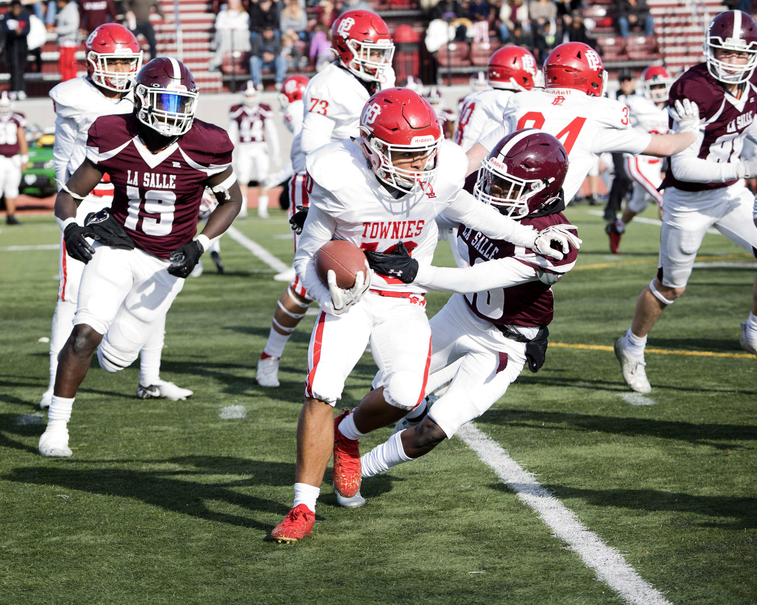 East Providence’s Denzy Suazo runs the ball for the Townies while competing against LaSalle in the annual Thanksgiving game.