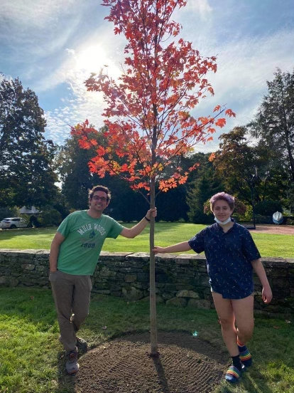 Domenic Napolitano (left) and Kelly Gorman stand beside one of the trees planted earlier this fall.